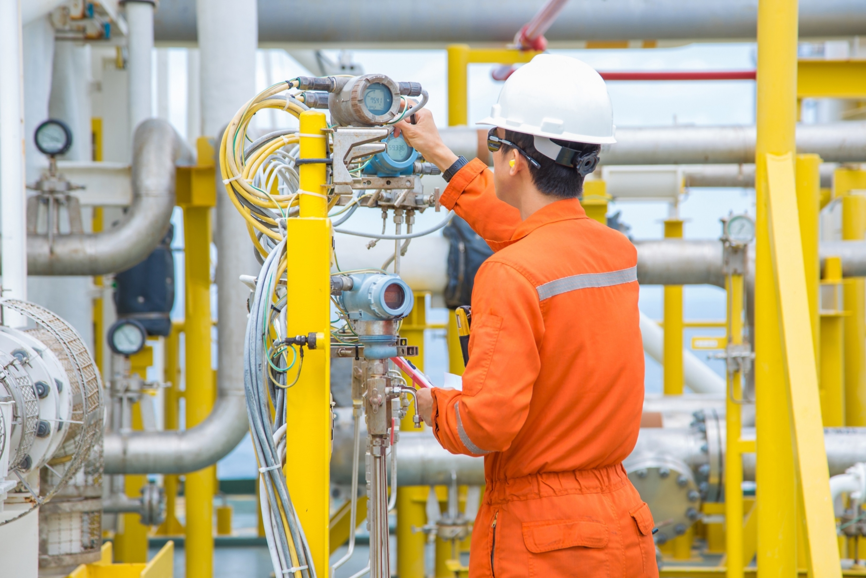 Workers checking a gauge
