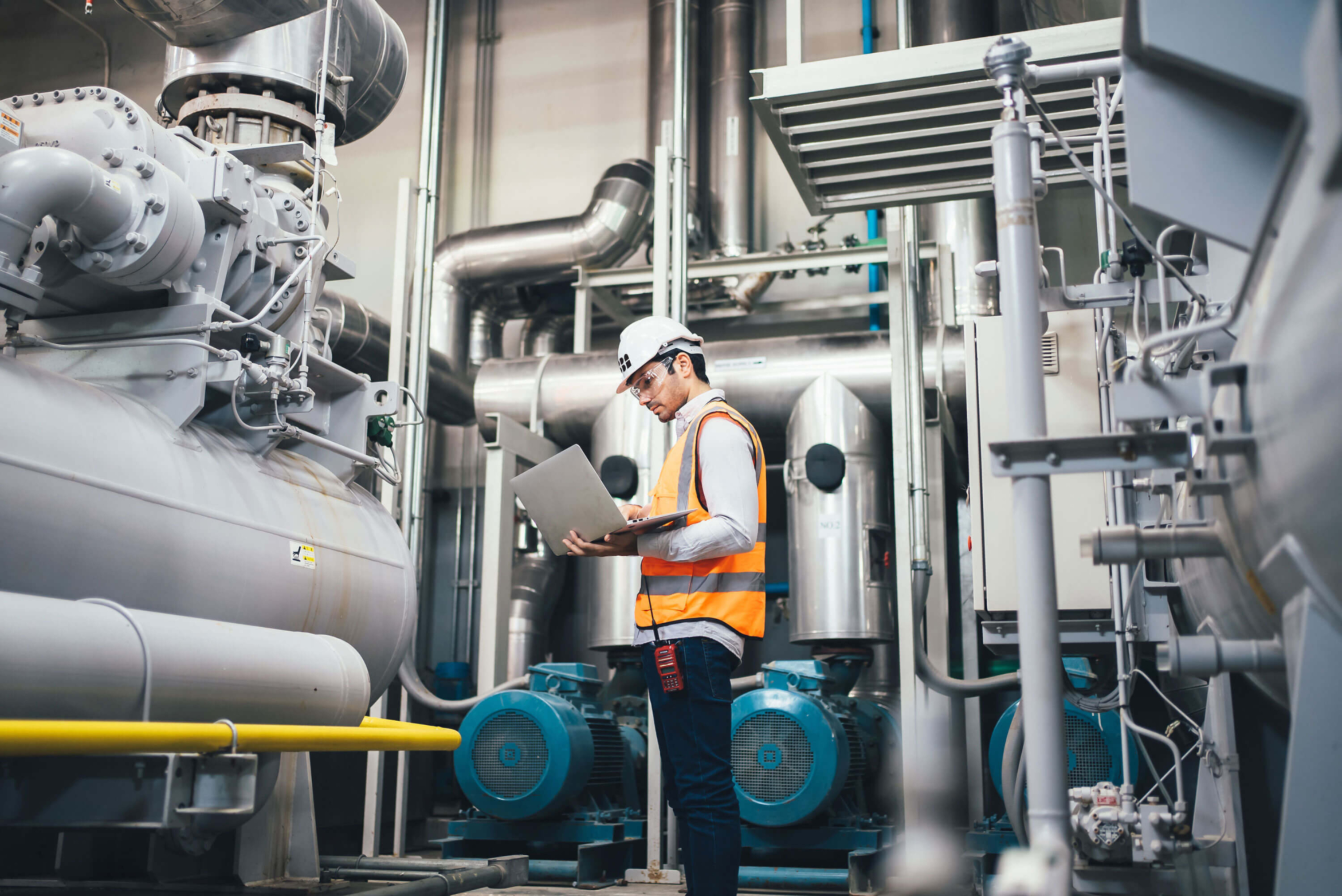 Employee on a laptop in an industrial facility