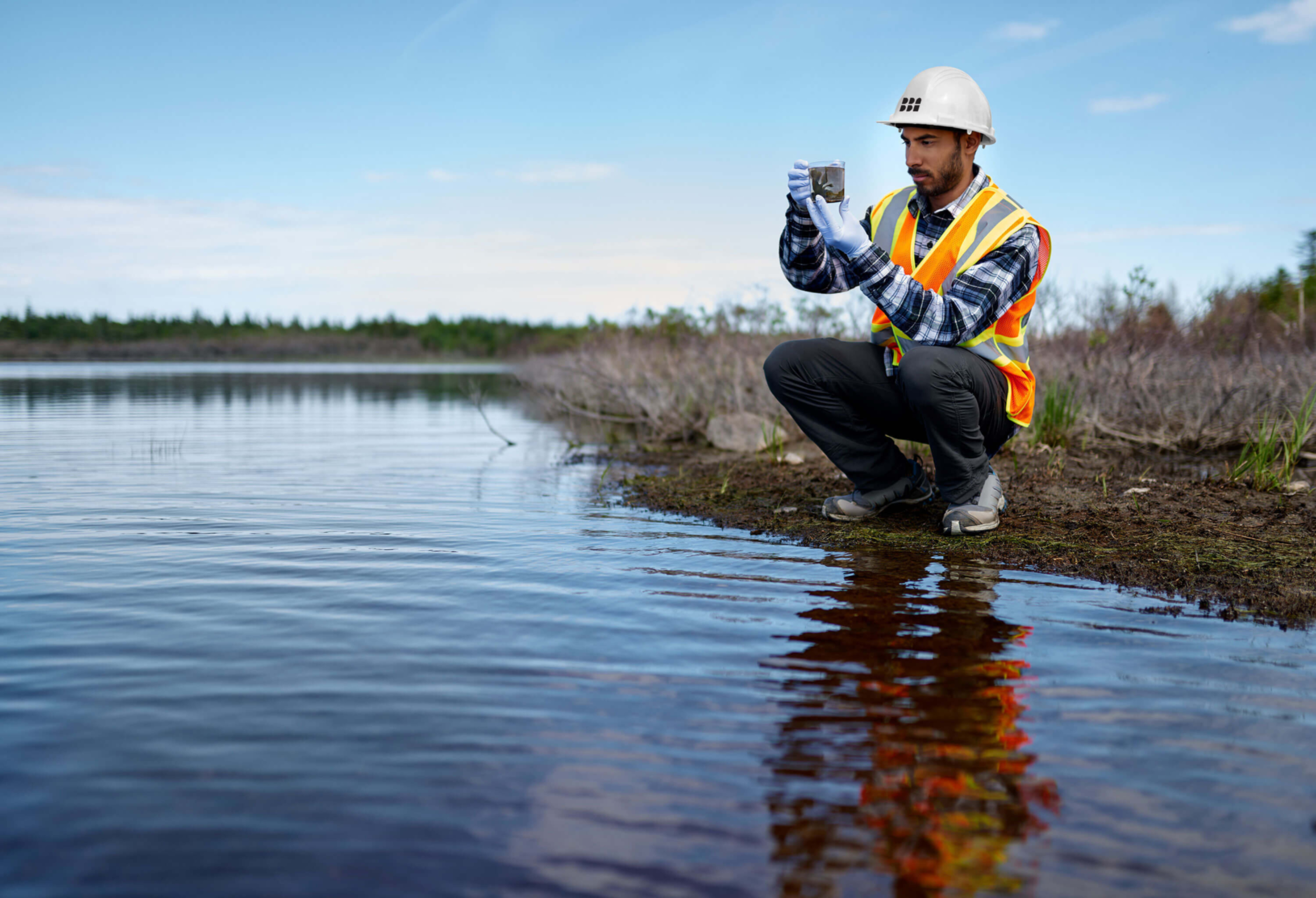 Environment - Man taking samples in a shallow river