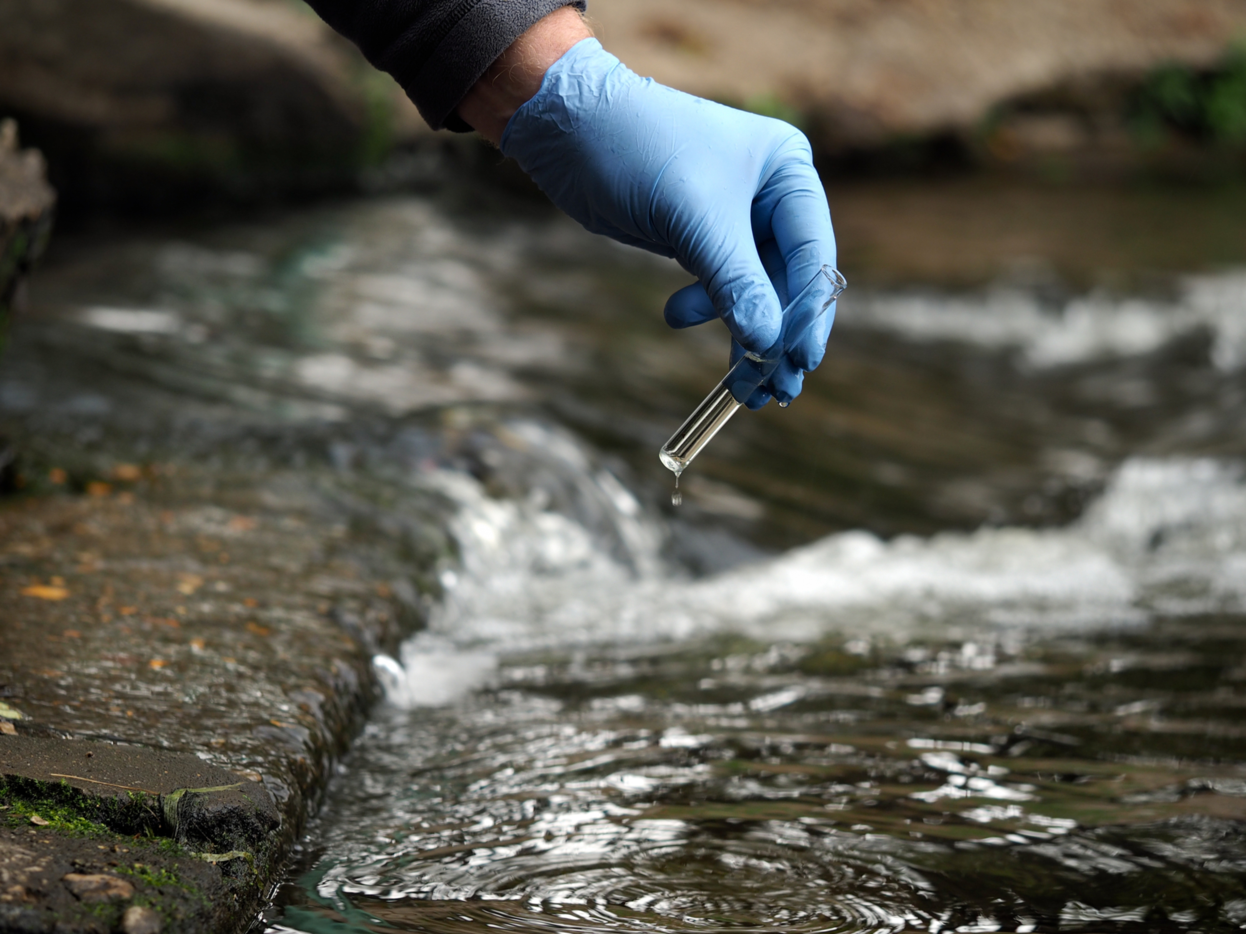 Person taking samples in a river
