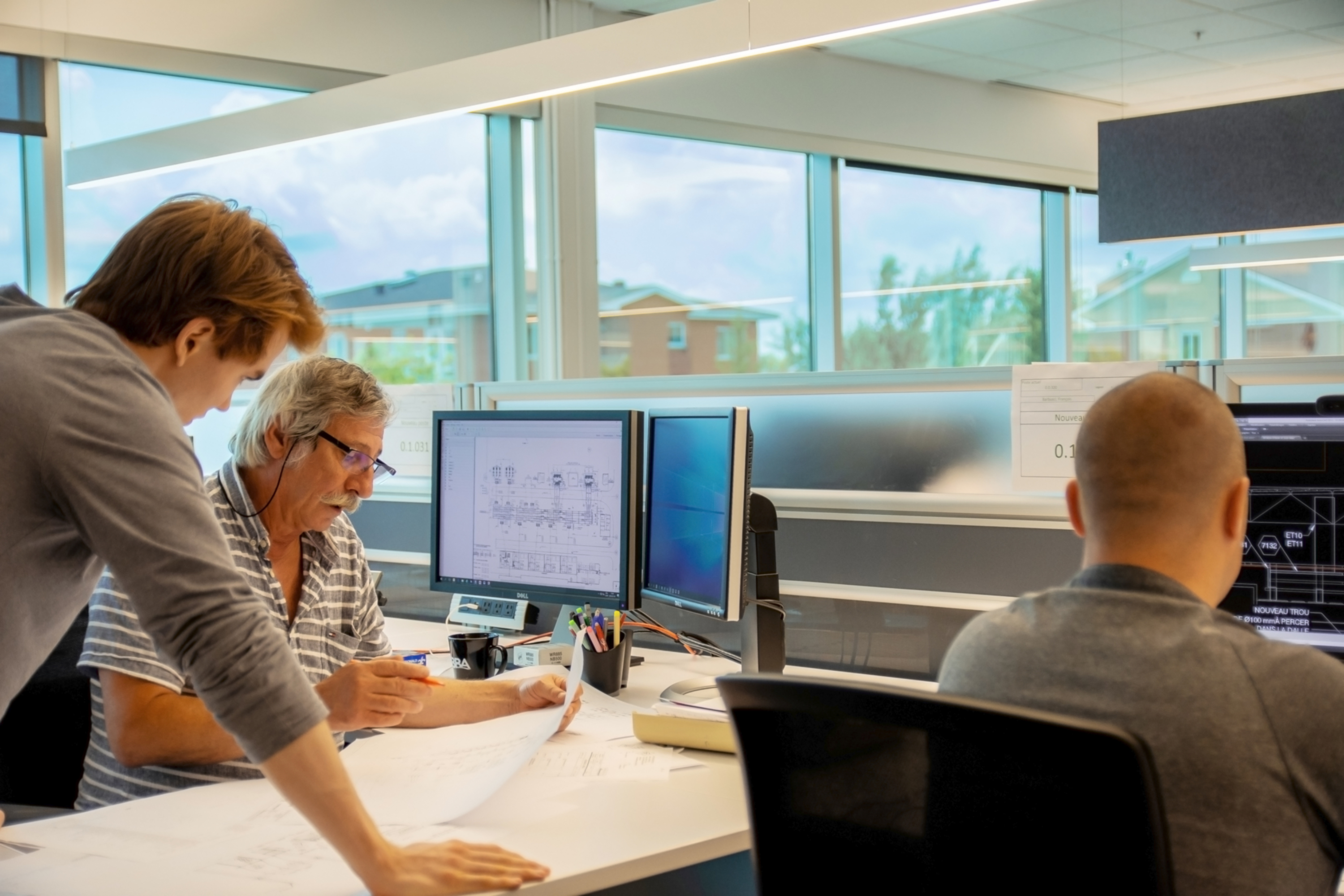 Diversity - Senior employee talking with employee over plans