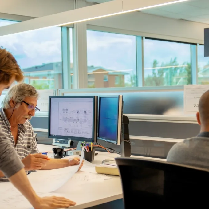 Diversity - Senior employee talking with employee over plans