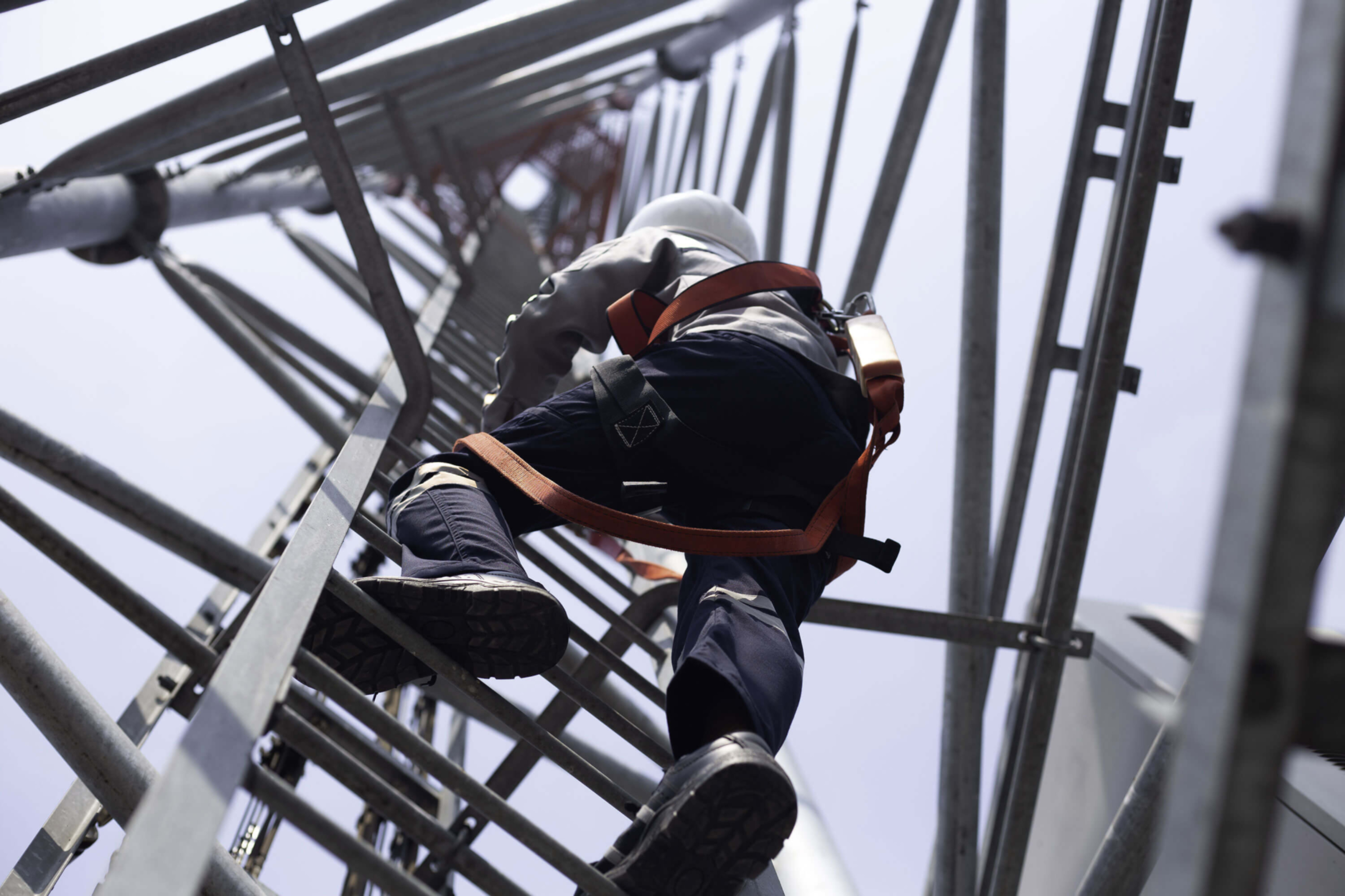Field Services  - Person climbing in a telecommunication tower