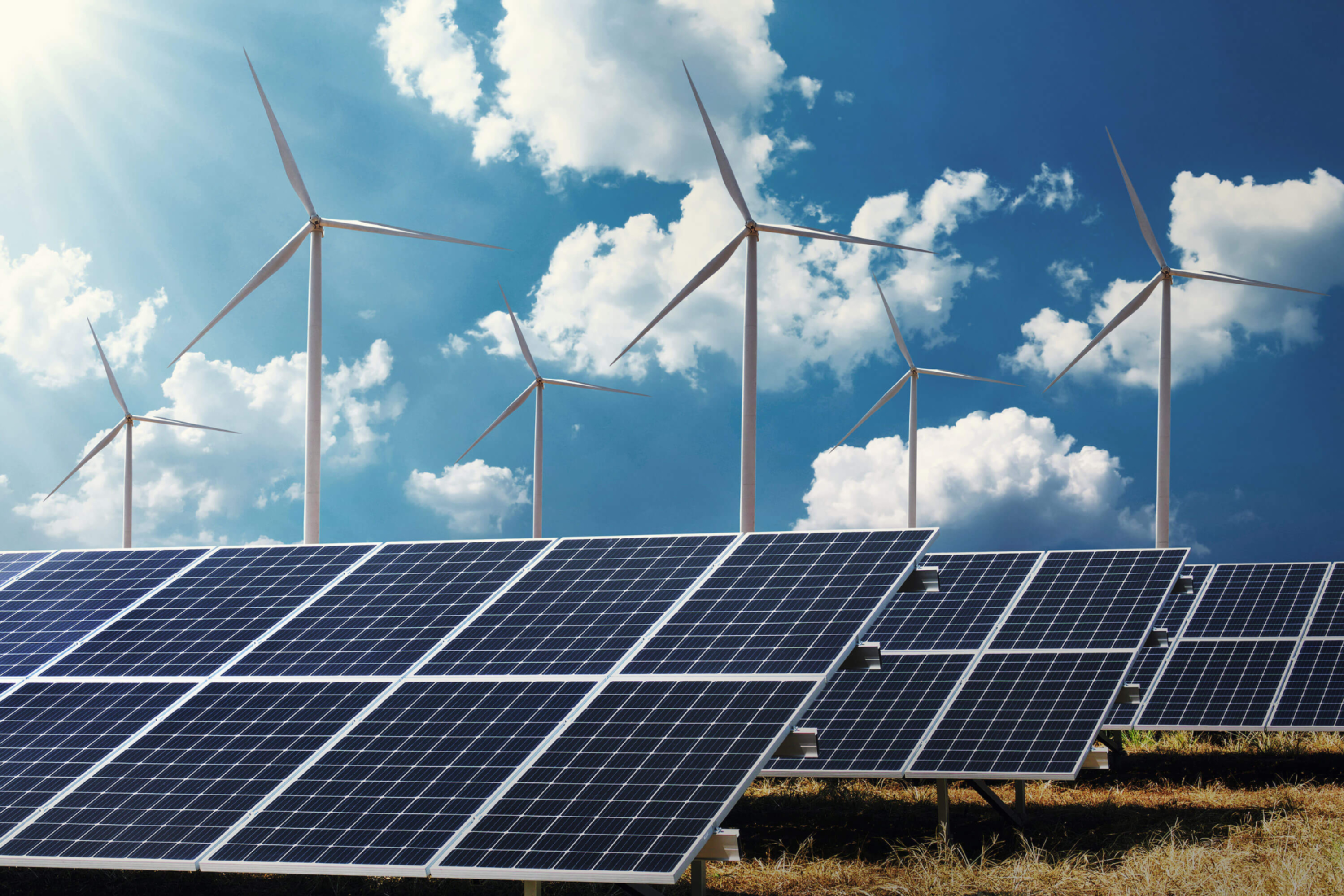 Power  - Wind and solar - Wind turbines and solar panels with blue sky