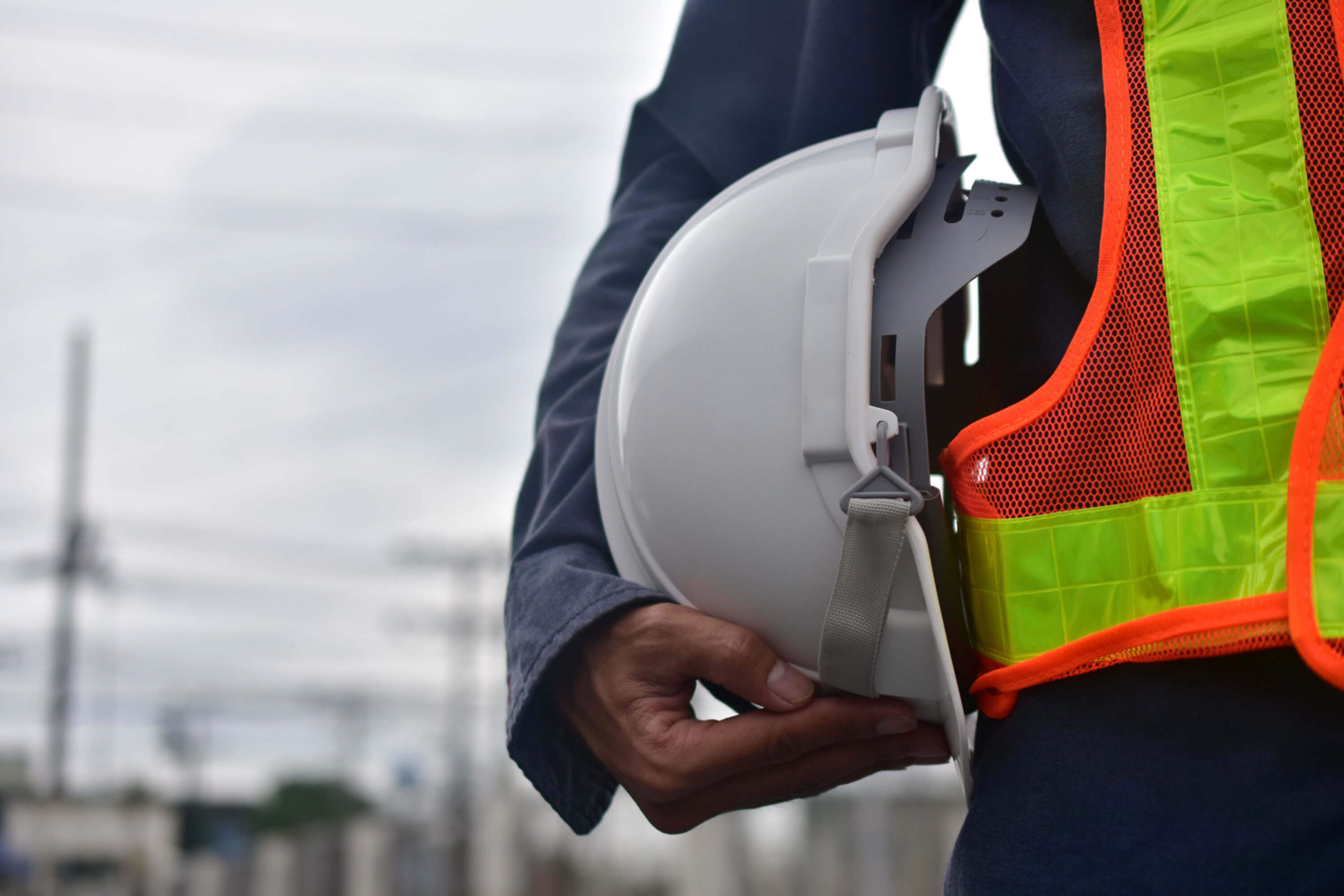 Health and safety - Person holding helmet