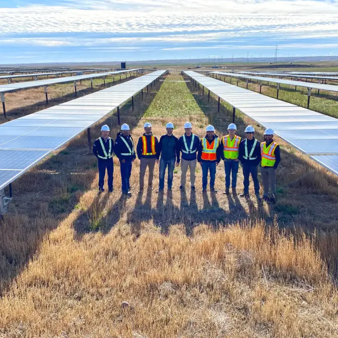Kilo Power Calgary men with safety gear on field with solar panels