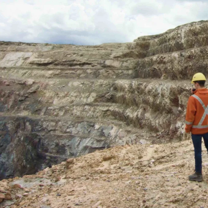 Mining - Mining engineer looking over mining pit